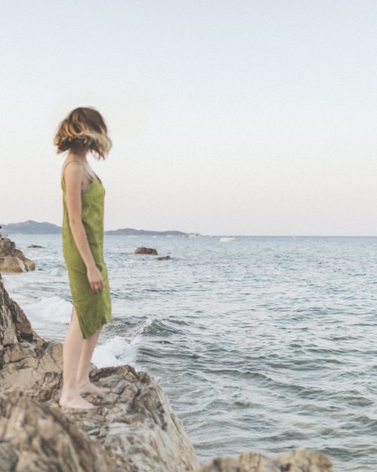 A person walking by the water